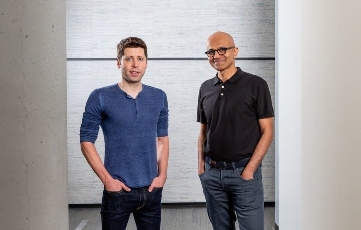 OpenAI CEO Sam Altman and Microsoft CEO Satya Nadella standing next to each other, smiling into the camera.