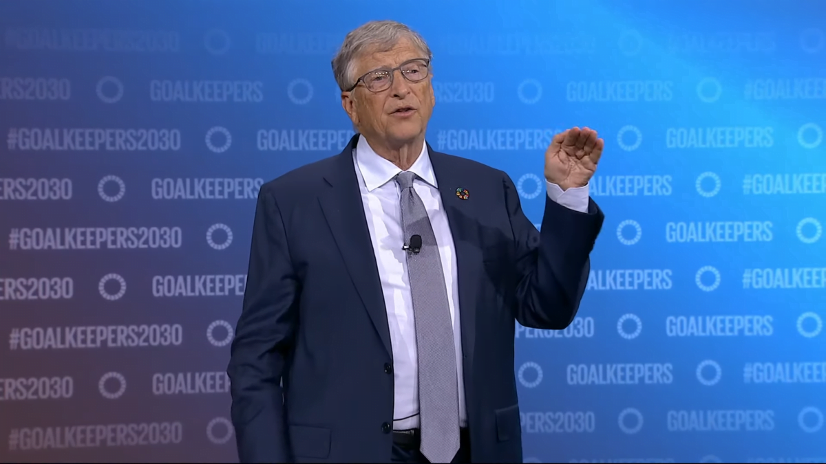 Bill Gates auf der Bühne bei der Gates Foundation, seine Hand zeit ein oberes Limit an.